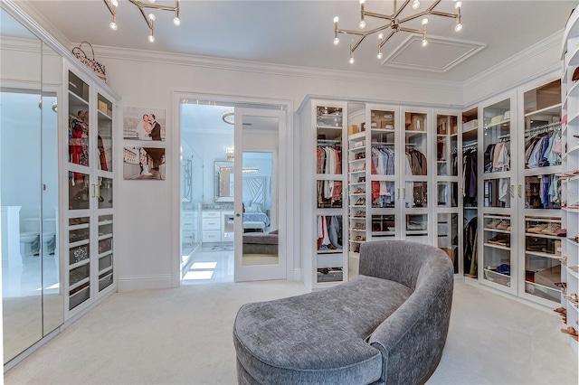 walk in closet with an inviting chandelier, carpet flooring, and french doors