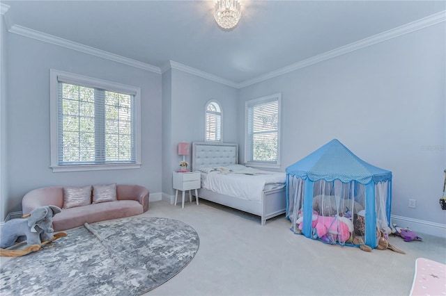 bedroom with ornamental molding, carpet flooring, and baseboards