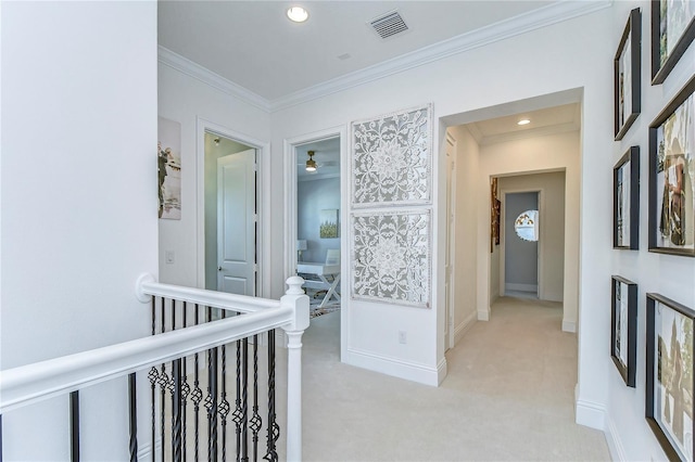 hall featuring light colored carpet, visible vents, ornamental molding, and an upstairs landing