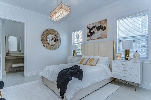 bedroom with ensuite bathroom, ornamental molding, an inviting chandelier, and baseboards