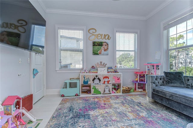 recreation room featuring ornamental molding and baseboards