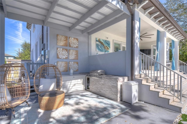 view of patio featuring an attached garage and exterior kitchen