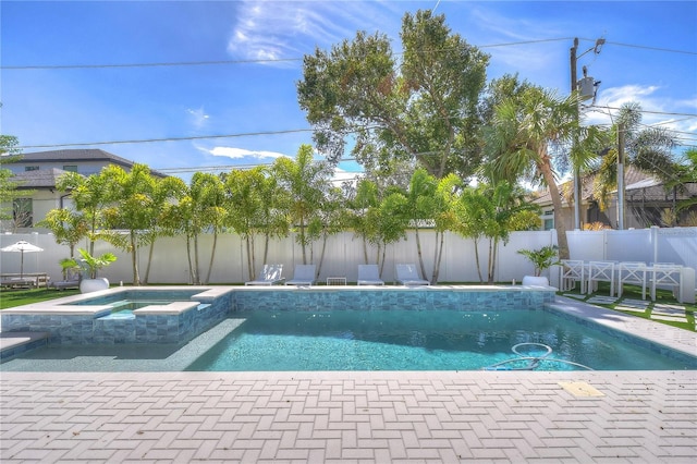 view of pool featuring a fenced backyard and a pool with connected hot tub