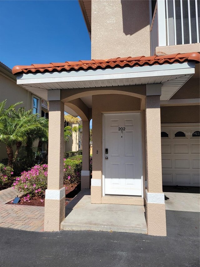 view of exterior entry featuring a garage