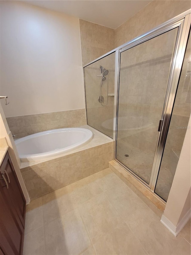 bathroom with tile patterned floors, plus walk in shower, and vanity