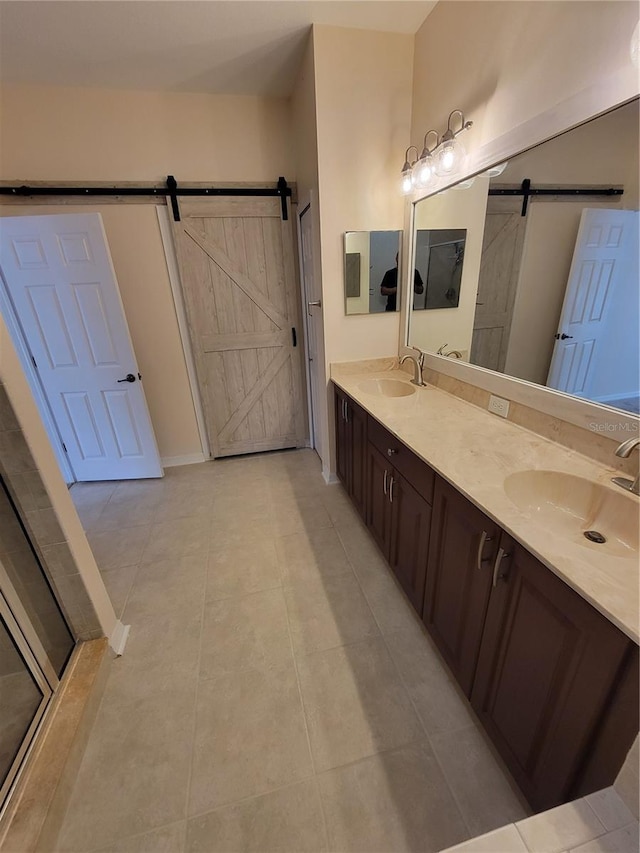 bathroom with vanity, a shower with shower door, and tile patterned floors