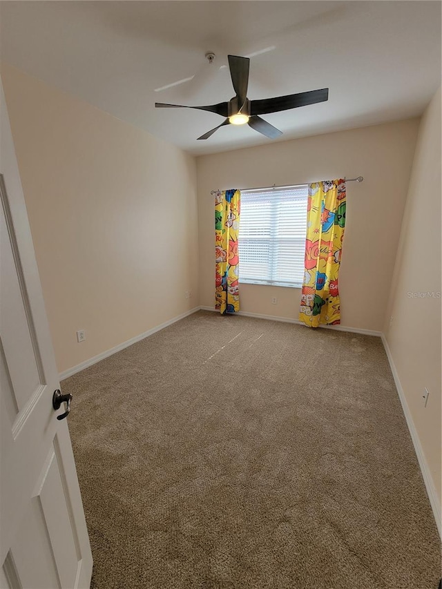 spare room with ceiling fan and carpet flooring