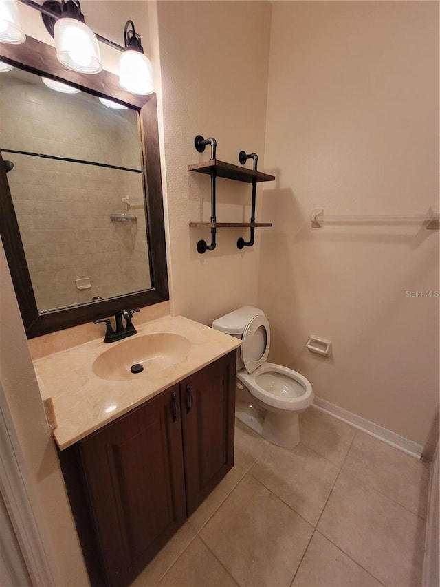 bathroom with vanity, toilet, and tile patterned flooring