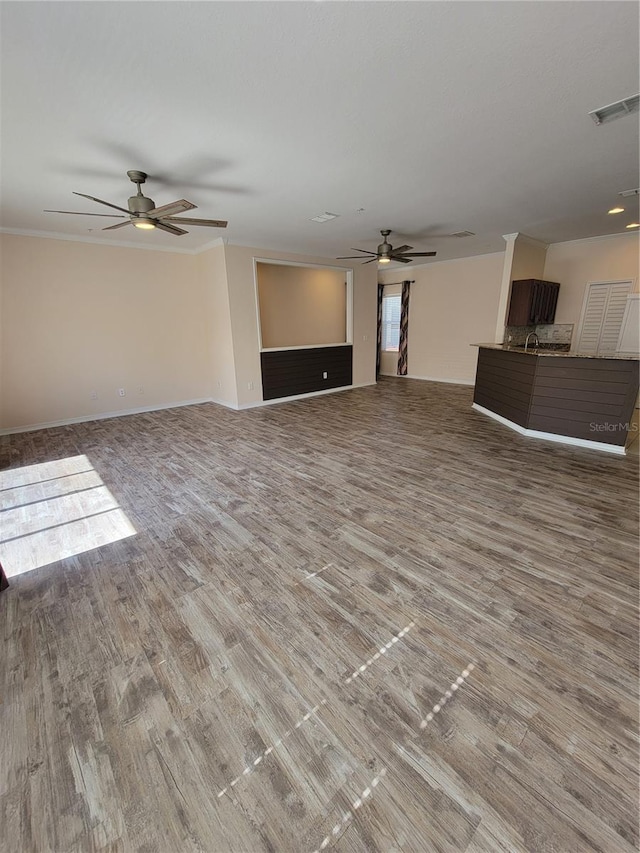 unfurnished living room featuring hardwood / wood-style floors and ceiling fan