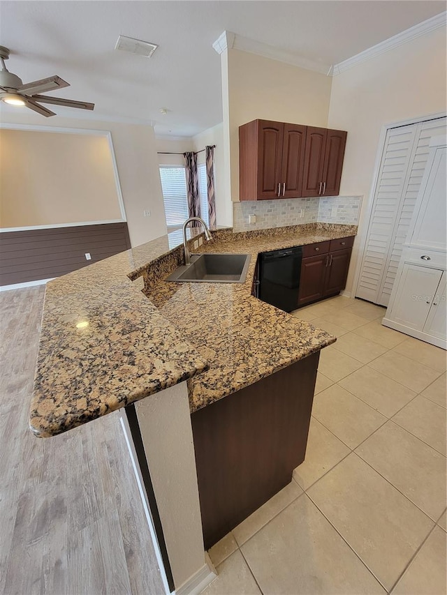 kitchen with sink, crown molding, black dishwasher, light stone countertops, and kitchen peninsula