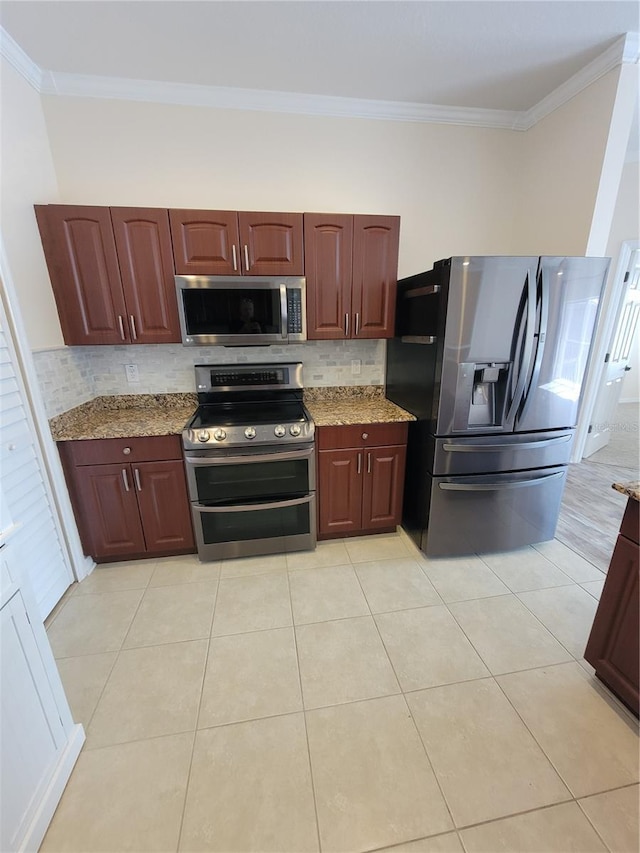 kitchen with light tile patterned floors, crown molding, stainless steel appliances, light stone counters, and tasteful backsplash