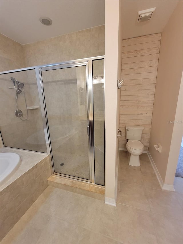 bathroom featuring tile patterned floors, plus walk in shower, and toilet