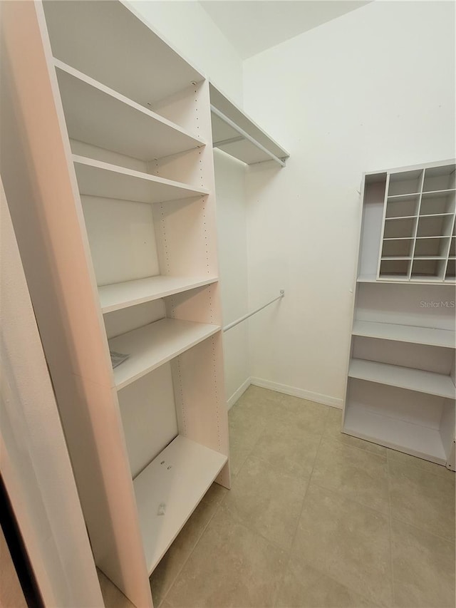 walk in closet featuring light tile patterned flooring