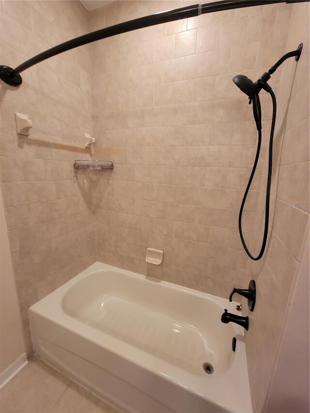 bathroom with tile patterned floors and tiled shower / bath combo