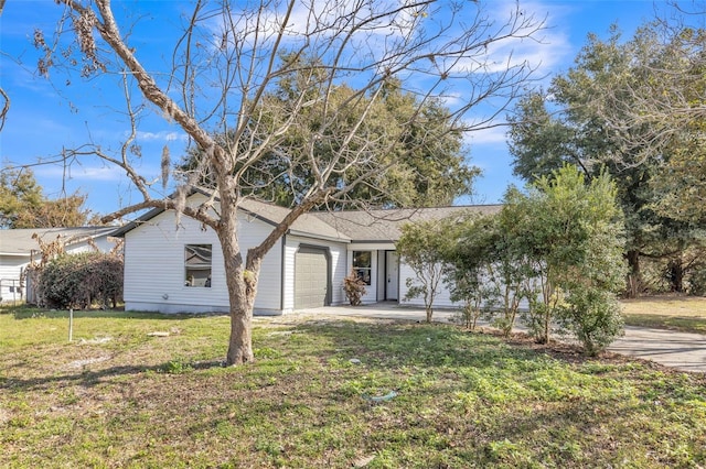 ranch-style house featuring a garage and a front yard