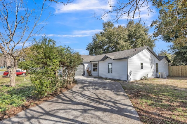 view of front of home featuring a garage and central AC unit