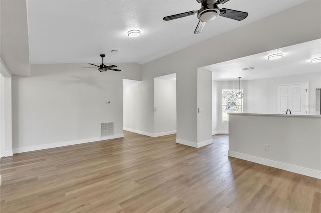 unfurnished living room with ceiling fan, lofted ceiling, and light hardwood / wood-style floors