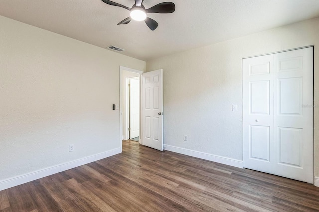 unfurnished bedroom with dark wood-type flooring and ceiling fan