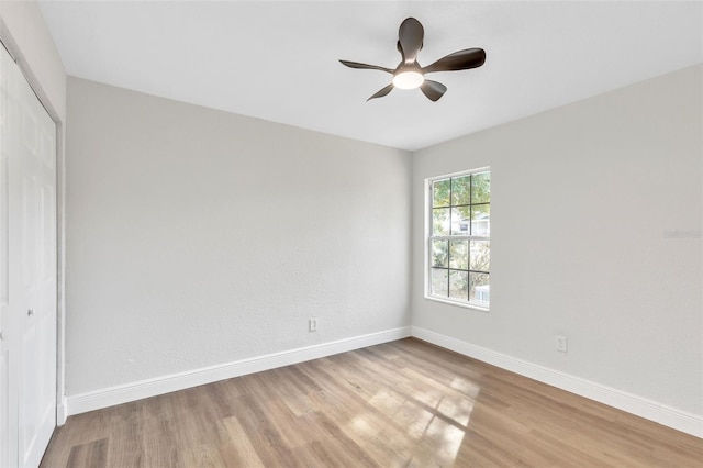 unfurnished bedroom featuring ceiling fan, a closet, and light hardwood / wood-style flooring