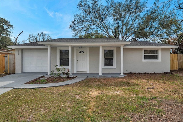 ranch-style house featuring a garage, covered porch, and a front lawn