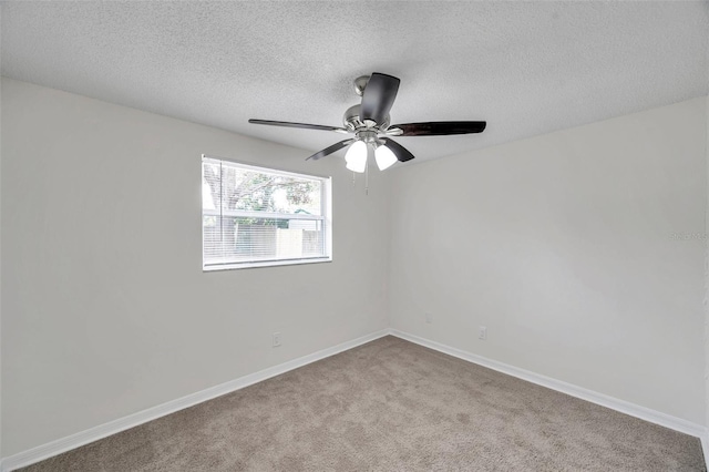 carpeted spare room with a textured ceiling