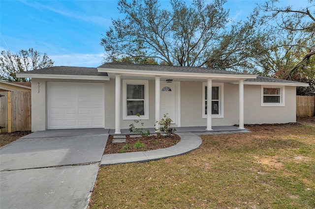 ranch-style house with a garage, a front yard, and covered porch