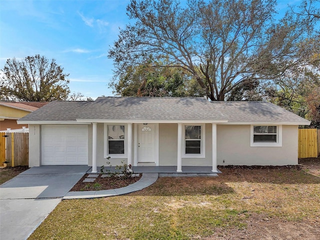 ranch-style home with a garage, a front lawn, and a porch