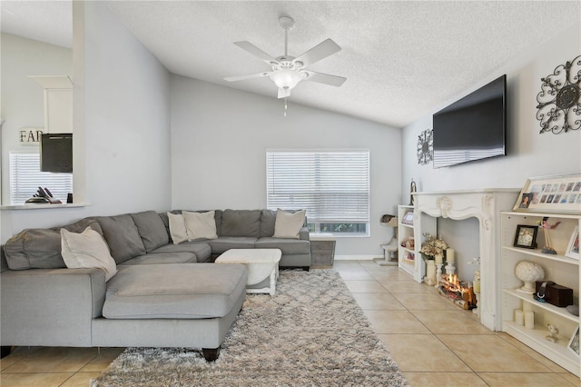 tiled living room featuring ceiling fan, lofted ceiling, and a textured ceiling