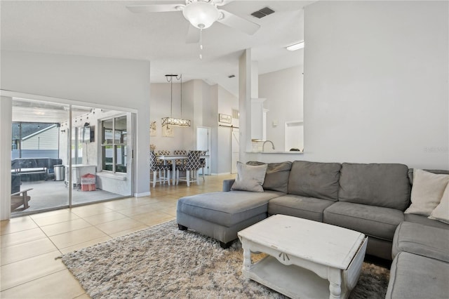 tiled living room featuring high vaulted ceiling and ceiling fan