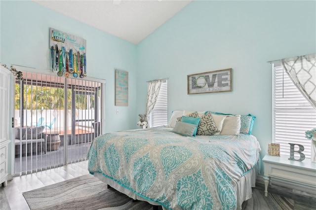 bedroom with access to exterior and high vaulted ceiling