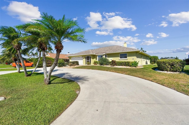 ranch-style home with a garage and a front lawn