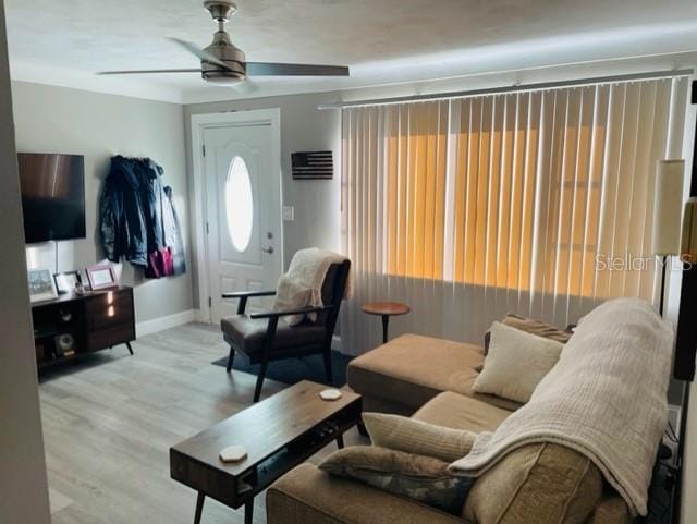 living room with light hardwood / wood-style floors and ceiling fan