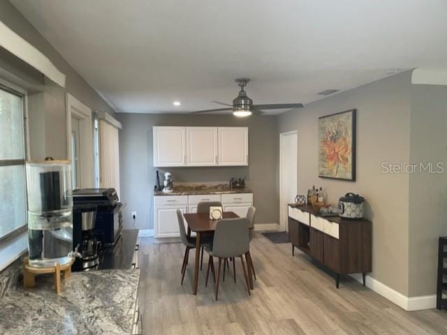 dining room featuring ceiling fan and light hardwood / wood-style floors