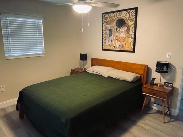 bedroom featuring wood-type flooring and ceiling fan