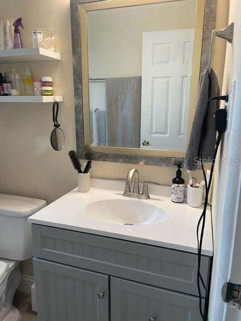 bathroom featuring vanity and toilet