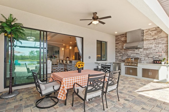 view of patio with ceiling fan, a grill, an outdoor kitchen, and outdoor dining space