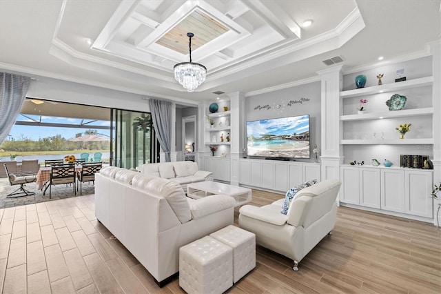 living room featuring a chandelier, built in shelves, visible vents, light wood-style floors, and ornamental molding