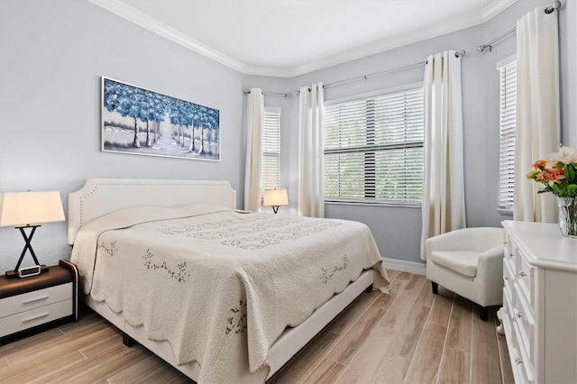 bedroom featuring wood tiled floor, crown molding, and baseboards