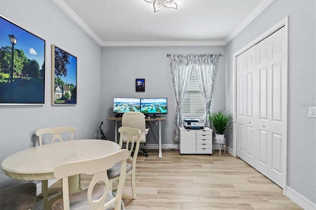 dining space with light wood-style flooring, ornamental molding, and baseboards