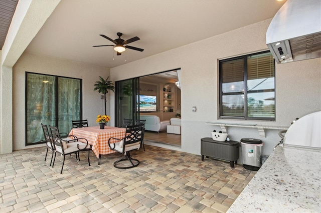 view of patio / terrace with outdoor dining area, area for grilling, and a ceiling fan