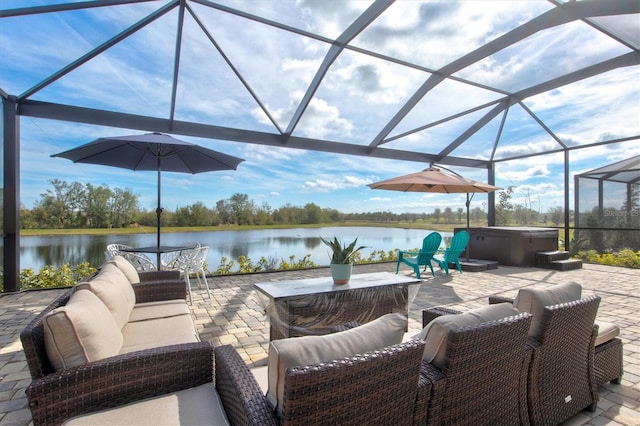 view of patio featuring a water view, a lanai, an outdoor living space, and a hot tub