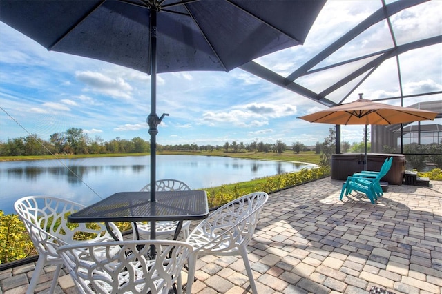 view of patio / terrace with outdoor dining space, a water view, a lanai, and a hot tub