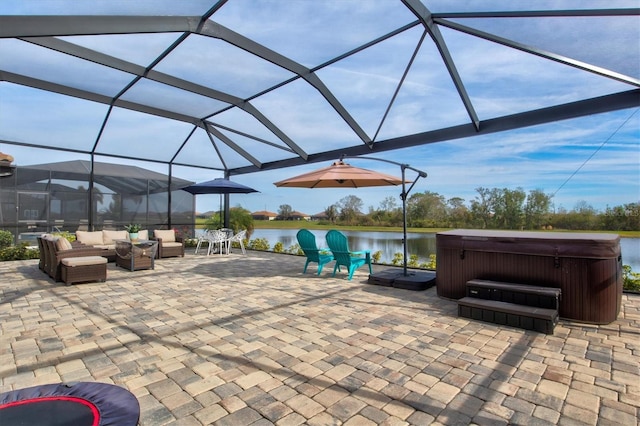 view of patio with a water view, a hot tub, a lanai, and an outdoor hangout area