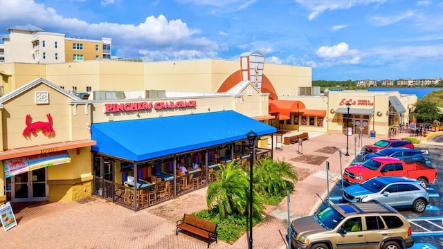 view of building exterior featuring uncovered parking and cooling unit