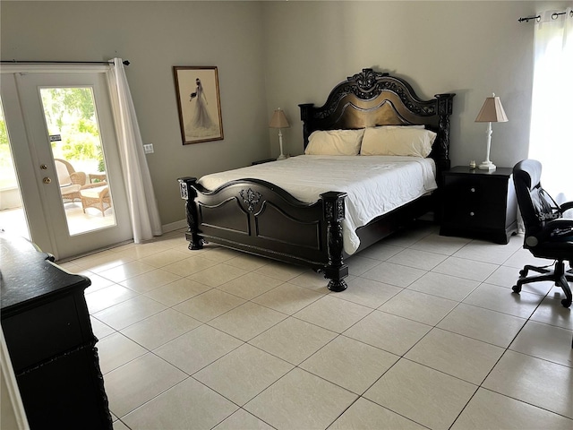 bedroom featuring light tile patterned flooring and access to exterior