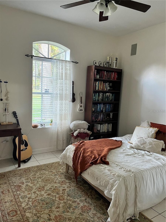 bedroom featuring light tile patterned flooring and ceiling fan