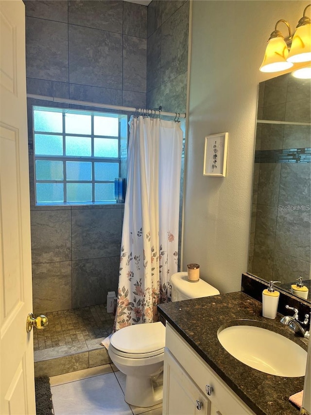 bathroom with toilet, vanity, and a shower with shower curtain