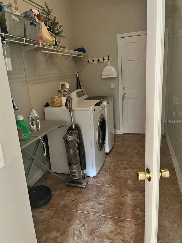 clothes washing area with separate washer and dryer