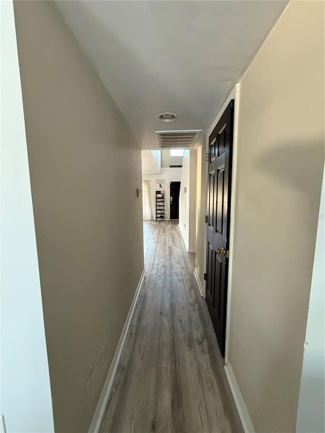 corridor featuring wood-type flooring