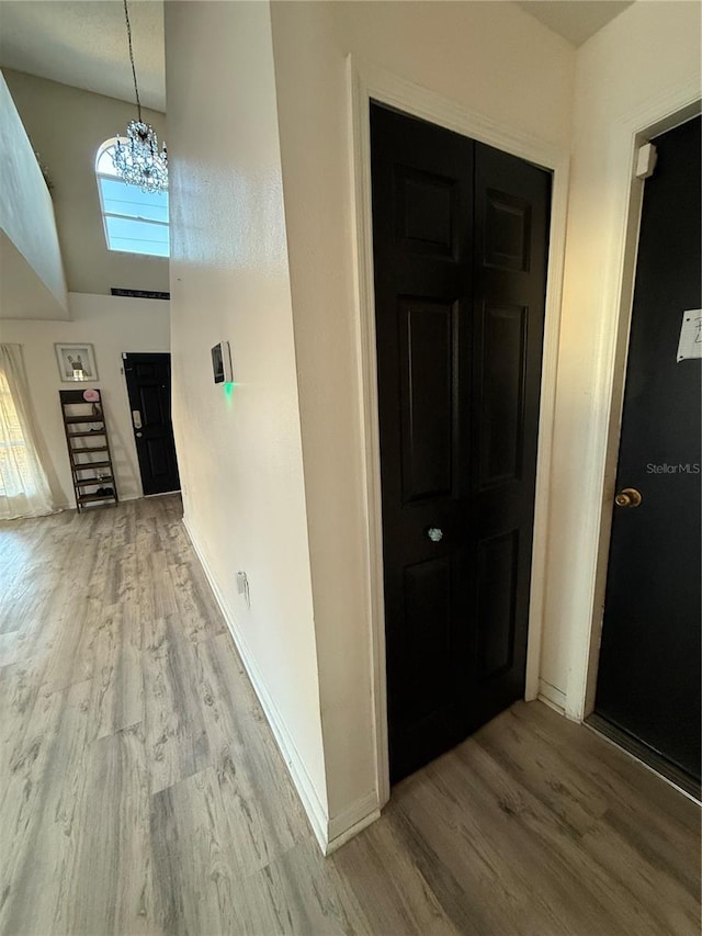 foyer featuring hardwood / wood-style flooring and a chandelier